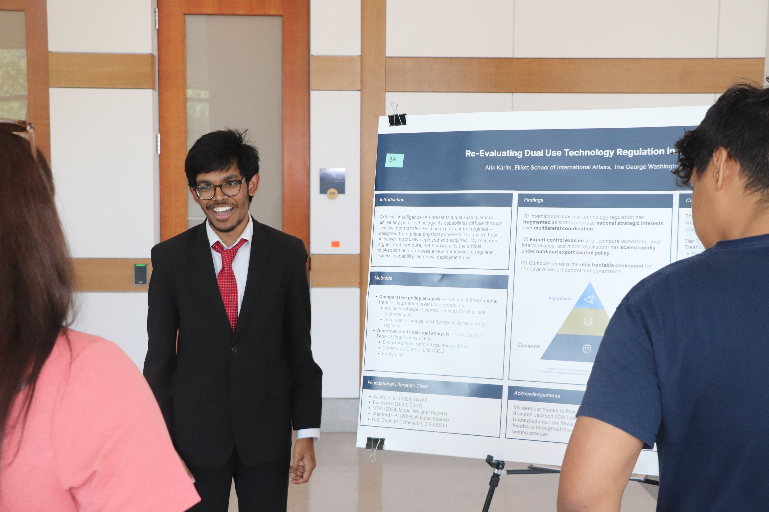 Presenting the Re-Evaluating Dual Use Technology Regulation in the Age of AI poster at the 2026 Elliott School Student Research Showcase.